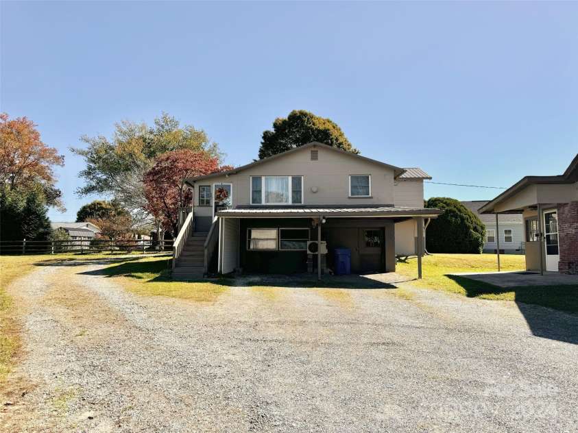 565 Neely Road, Brevard, NC 28712.  MLS# CAR4074647, YatesRealty ID 55. Carport and Entrance to Apartment #1