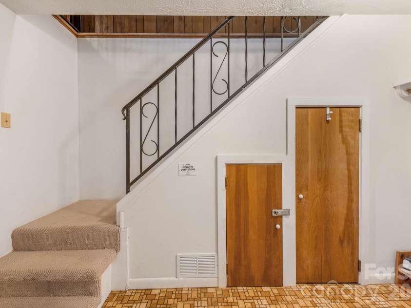 74 Lanzi Ledge Road, Leicester, NC 28748.  MLS# CAR4423050, YatesRealty ID 55008. Stairs to upper Level/Kitchen/Dining