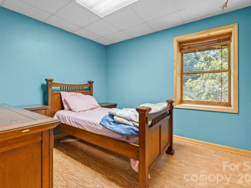1003 Deerwood Road, Piney Creek, NC 28663.  MLS# CAR4431542, YatesRealty ID 55017. Lower Level Bedroom 2