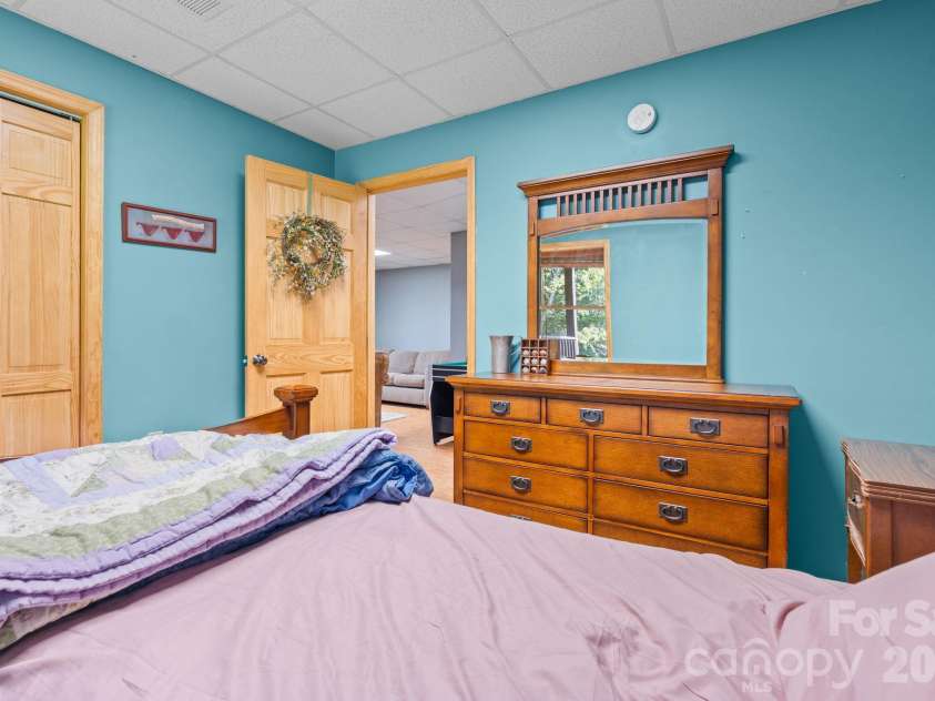 1003 Deerwood Road, Piney Creek, NC 28663.  MLS# CAR4431542, YatesRealty ID 55017. Lower Level Bedroom 2