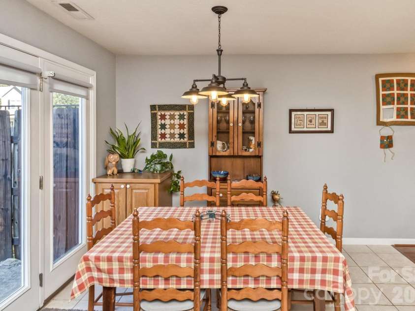 5 Lilac Fields Way, Arden, NC 28704.  MLS# CAR4425374, YatesRealty ID 55081. Dining area with overhead chandelier