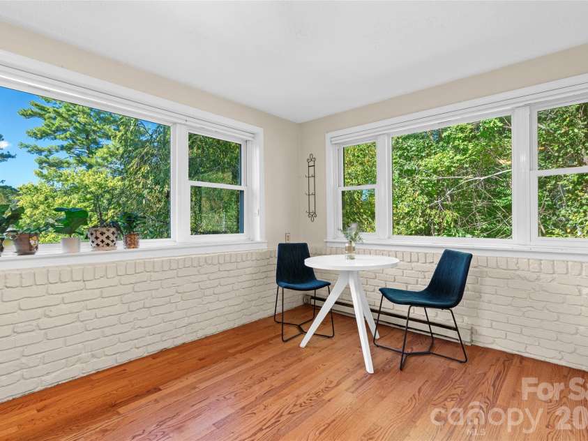 18 Northwood Road, Asheville, NC 28804.  MLS# CAR4429580, YatesRealty ID 55146. Bright eat-in kitchen featuring generous windows, ample natural light, and a comfortable space for casual dining.