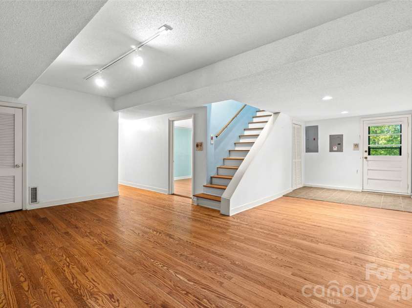 18 Northwood Road, Asheville, NC 28804.  MLS# CAR4429580, YatesRealty ID 55146. Spacious lower-level den provides a second living area with room to relax, entertain, or create a media space.