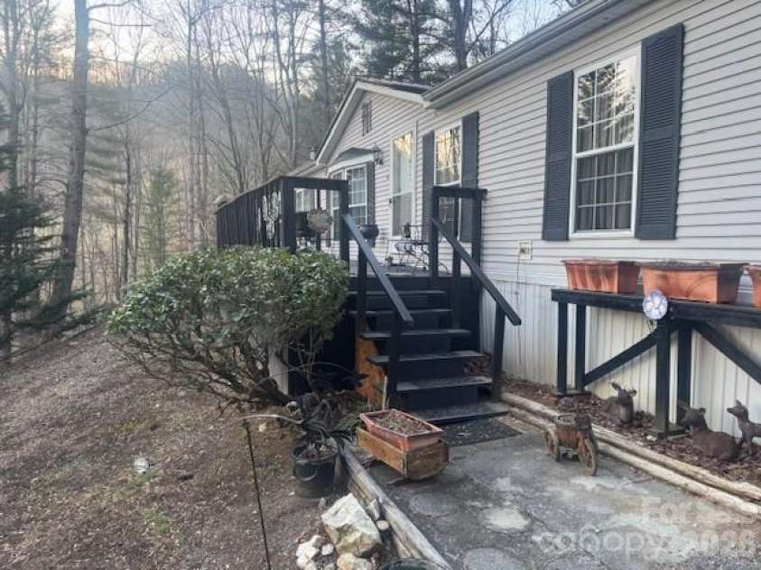 1372 Lickskillet Road, Burnsville, NC 28714.  MLS# CAR4333089, YatesRealty ID 55249. Front of house with raised garden beds.