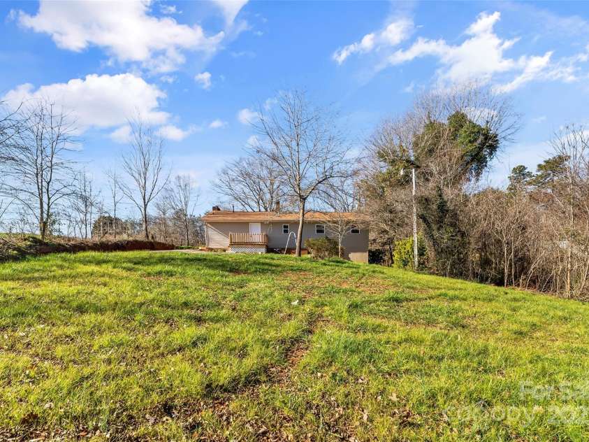 3100 NC Hwy 18 Highway, Vale, NC 28168.  MLS# CAR4208975, YatesRealty ID 5528. Back of Home and Back Yard