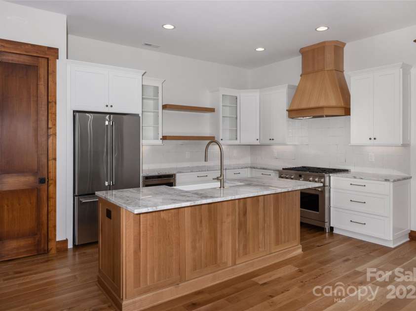 750 Silver Springs Drive, Banner Elk, NC 28604.  MLS# CAR4160928, YatesRealty ID 553. Chef's kitchen with custom solid wood cabinets, stainless steel appliances, farmhouse sink & dining room overlooking 2 story living room