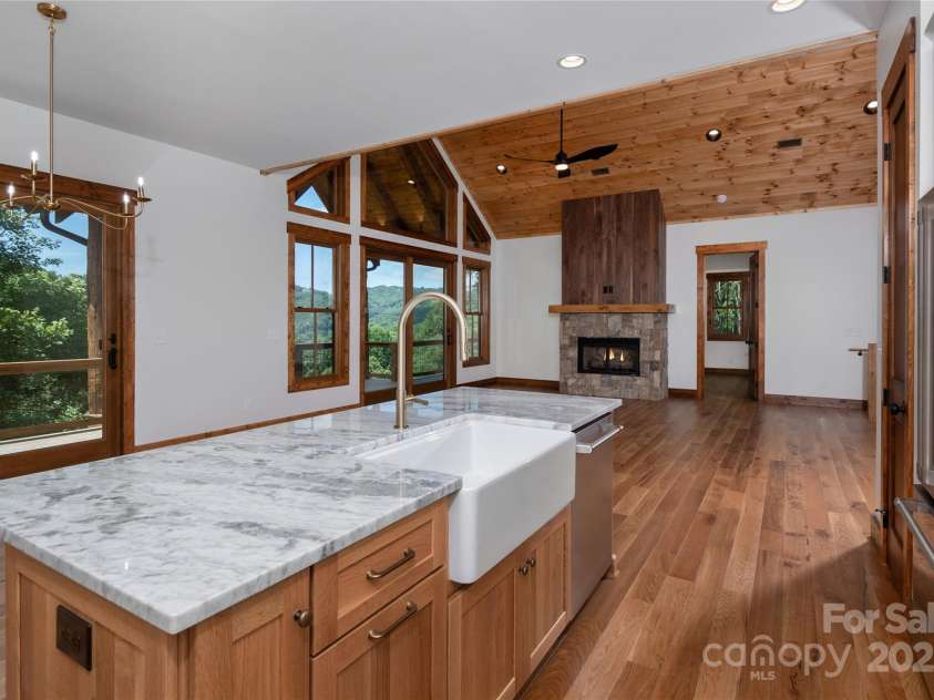 750 Silver Springs Drive, Banner Elk, NC 28604.  MLS# CAR4160928, YatesRealty ID 553. Chef's kitchen with custom solid wood cabinets, stainless steel appliances, farmhouse sink & dining room overlooking 2 story living room