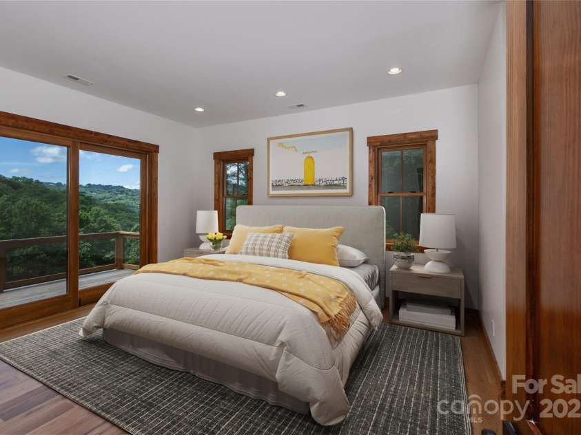 750 Silver Springs Drive, Banner Elk, NC 28604.  MLS# CAR4160928, YatesRealty ID 553. Main floor primary suite with incredible mountain views, access to porch & 2 walk-in closets. Primary bathroom with double vanities & backlit mirrors, soaking bathtub, shower & water closet.