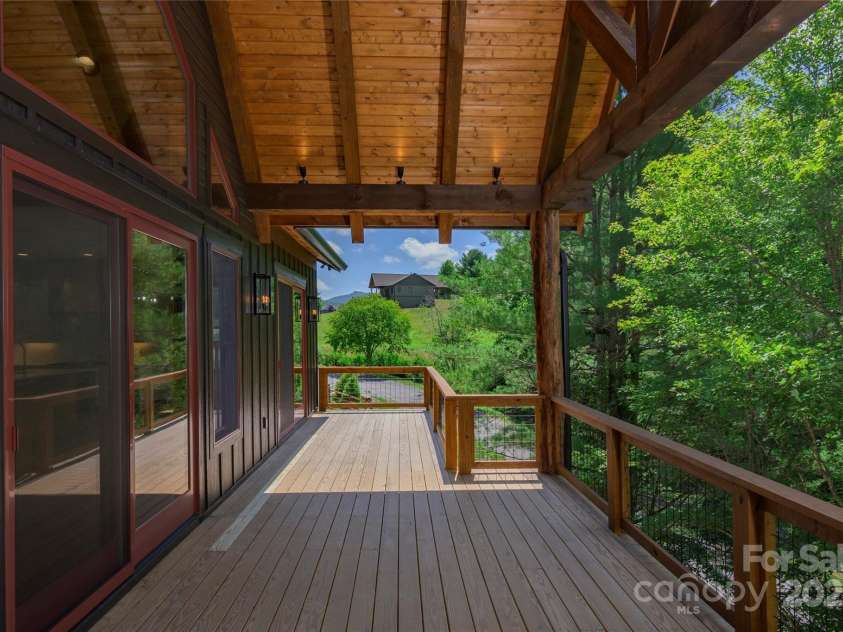750 Silver Springs Drive, Banner Elk, NC 28604.  MLS# CAR4160928, YatesRealty ID 553. Over 1,200 square feet of outdoor space including main level porte-cochere, covered porches with majestic, private mountain & neighborhood pond views