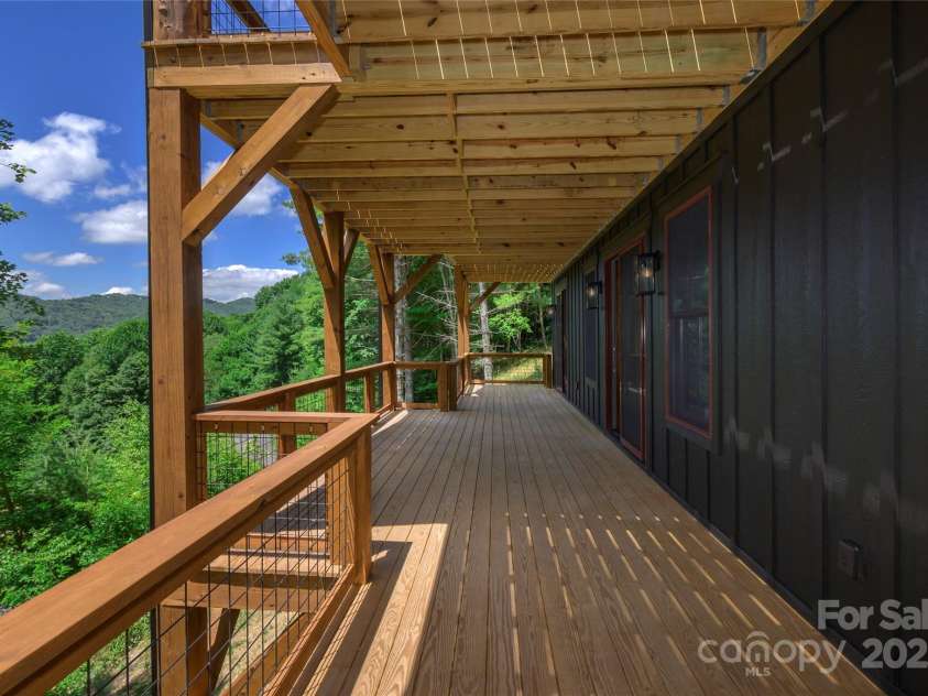 750 Silver Springs Drive, Banner Elk, NC 28604.  MLS# CAR4160928, YatesRealty ID 553. Over 1,200 square feet of outdoor space including main level porte-cochere, covered porches with majestic, private mountain & neighborhood pond views