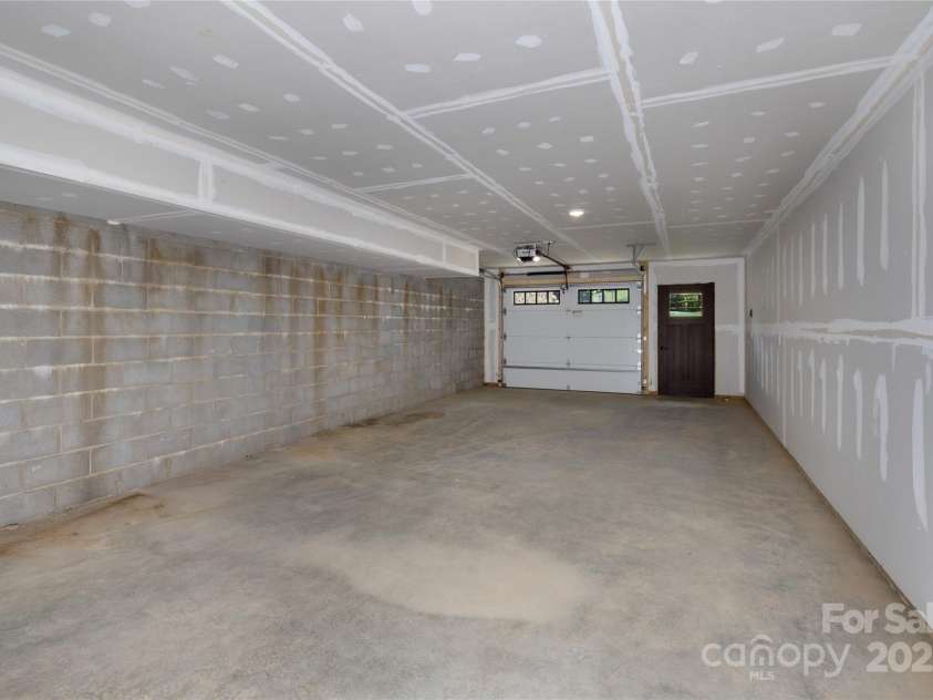 750 Silver Springs Drive, Banner Elk, NC 28604.  MLS# CAR4160928, YatesRealty ID 553. Tandem two car garage with equipment/tool and/or additional storage on lower level