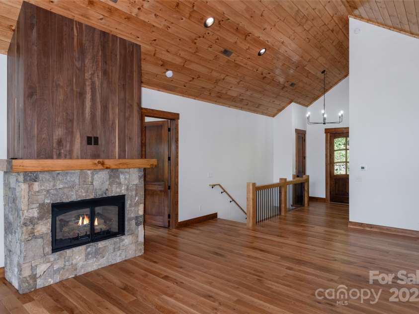 750 Silver Springs Drive, Banner Elk, NC 28604.  MLS# CAR4160928, YatesRealty ID 553. Vaulted living room with floor to ceiling sliding doors & windows and gas fireplace