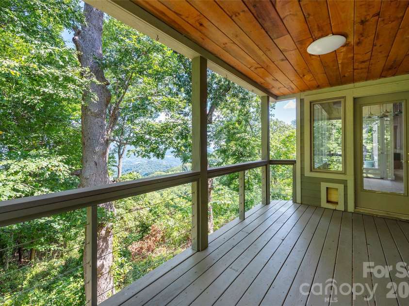 226 Strickland Drive, Waynesville, NC 28785.  MLS# CAR4407151, YatesRealty ID 55329. Lovely views from the side upper main covered deck