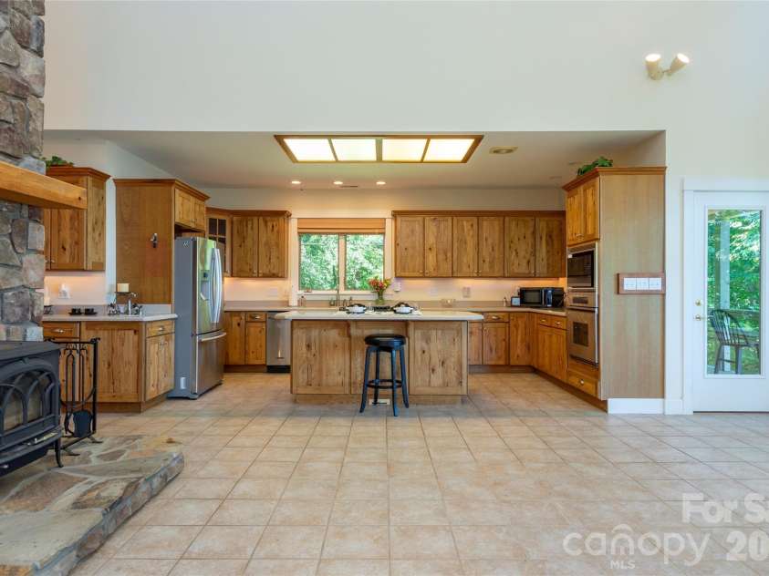 226 Strickland Drive, Waynesville, NC 28785.  MLS# CAR4407151, YatesRealty ID 55329. Open concept kitchen, dining and great room