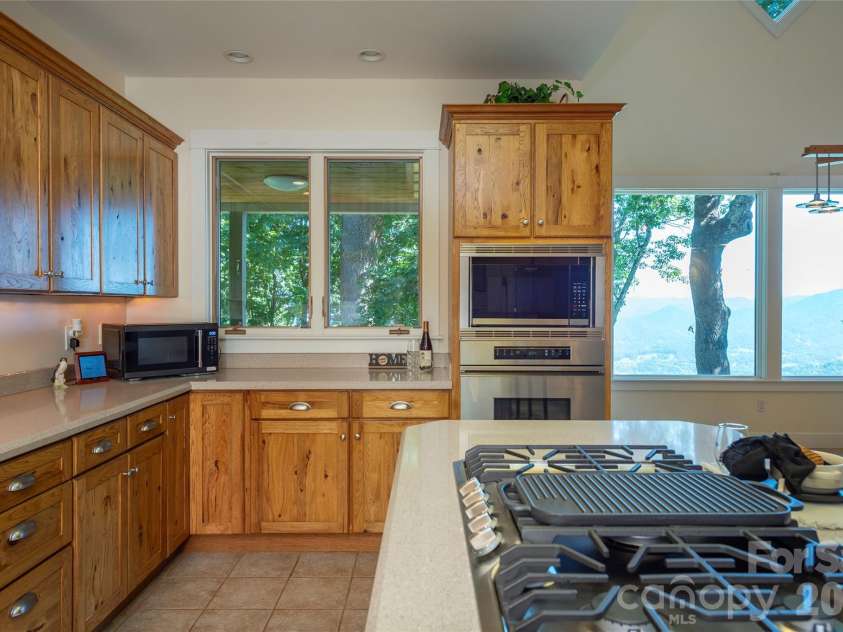 226 Strickland Drive, Waynesville, NC 28785.  MLS# CAR4407151, YatesRealty ID 55329. Open concept Kitchen with new gas range and microwave