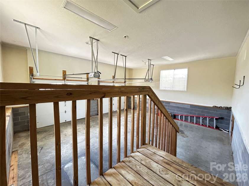 224 Pete Luther Road, Candler, NC 28715.  MLS# CAR4432613, YatesRealty ID 55340. Stairs into theGarage