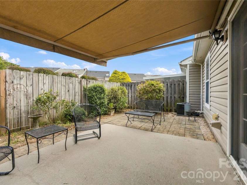 1001 Old Chestnut Way, Cramerton, NC 28032.  MLS# CAR4431972, YatesRealty ID 55342. Exterior private patio with remote controlled retractable awning