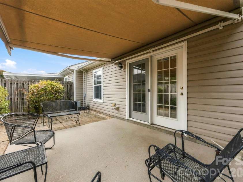 1001 Old Chestnut Way, Cramerton, NC 28032.  MLS# CAR4431972, YatesRealty ID 55342. Exterior private patio with remote controlled retractable awning