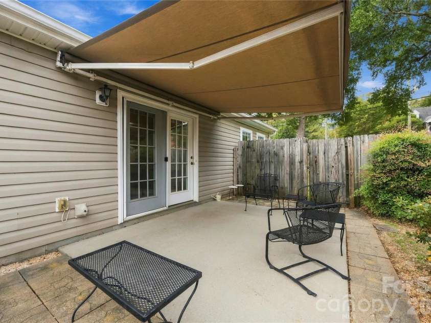 1001 Old Chestnut Way, Cramerton, NC 28032.  MLS# CAR4431972, YatesRealty ID 55342. Exterior private patio with remote controlled retractable awning
