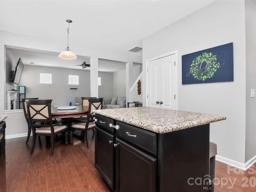 78066 Rillstone Drive, Lancaster, SC 29720.  MLS# CAR4431291, YatesRealty ID 55424. Kitchen island with 2 barstools, open to living area.