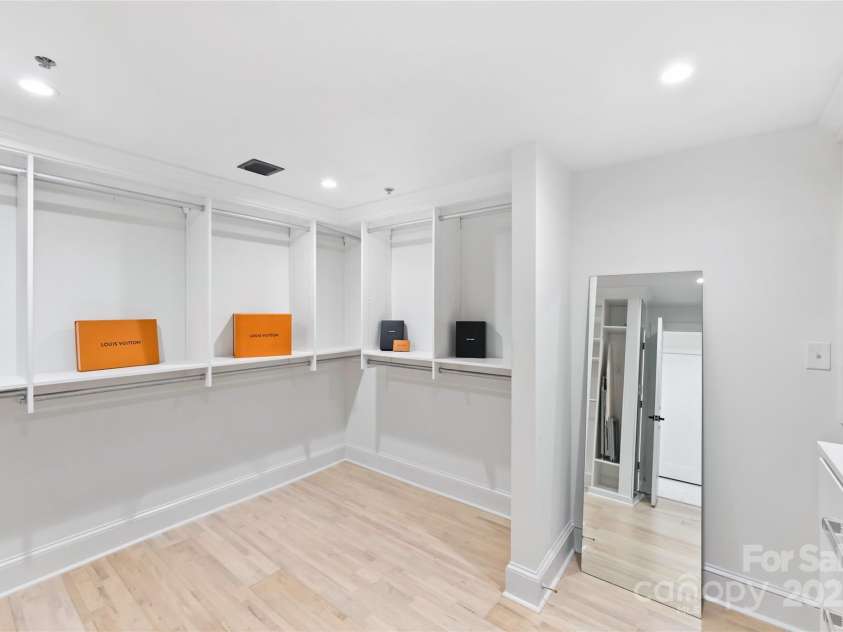 127 Tryon Street, Charlotte, NC 28202.  MLS# CAR4308165, YatesRealty ID 5550. Custom walk-in primary closet with  built-in shelving