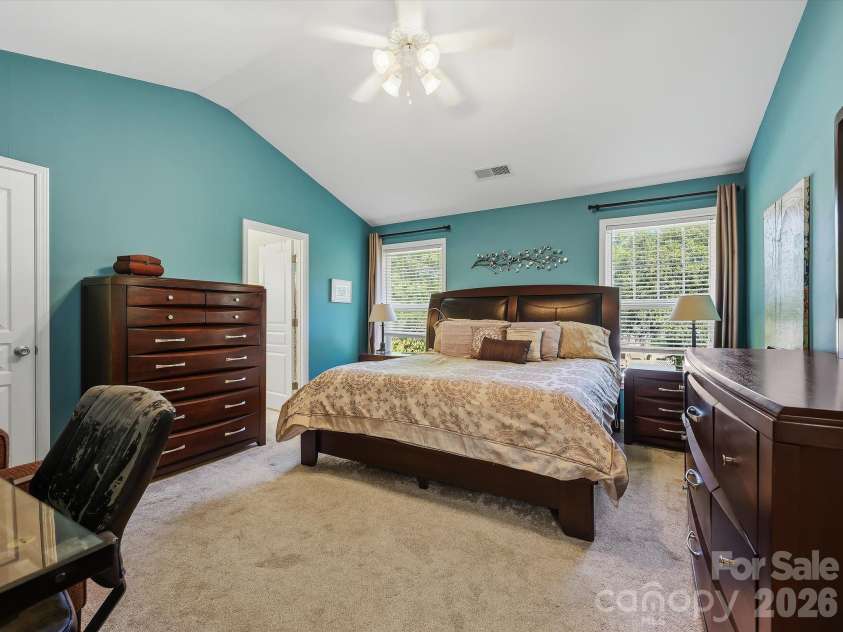 11732 Windy Mist Way, Huntersville, NC 28078.  MLS# CAR4431912, YatesRealty ID 55502. The spacious Primary Suite on the upper level features a vaulted ceiling, abundant natural light, and generous room for a comfortable private retreat.