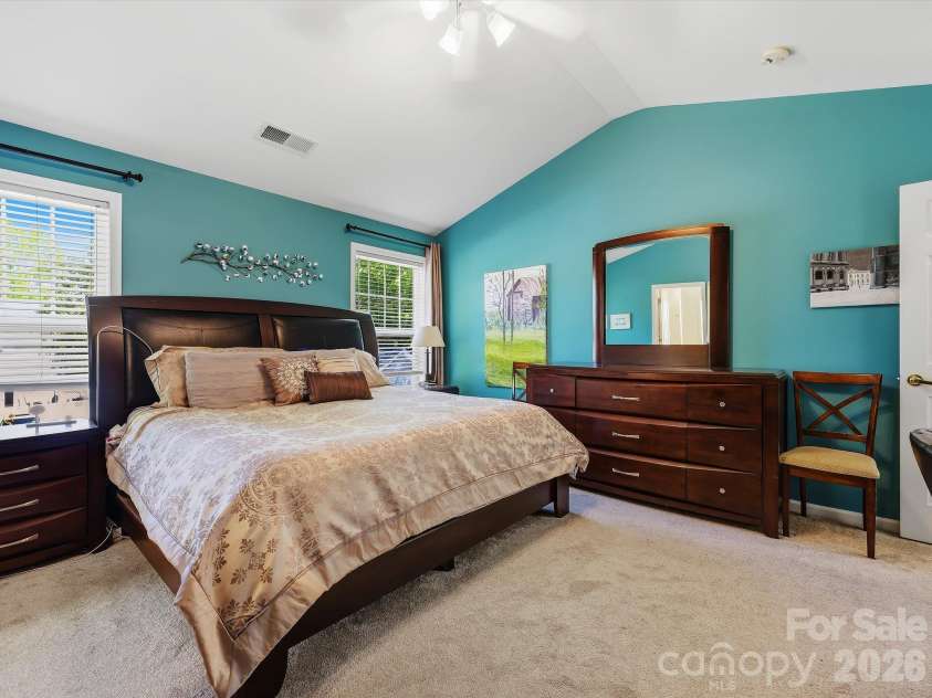 11732 Windy Mist Way, Huntersville, NC 28078.  MLS# CAR4431912, YatesRealty ID 55502. The spacious Primary Suite on the upper level features a vaulted ceiling, abundant natural light, and generous room for a comfortable private retreat.