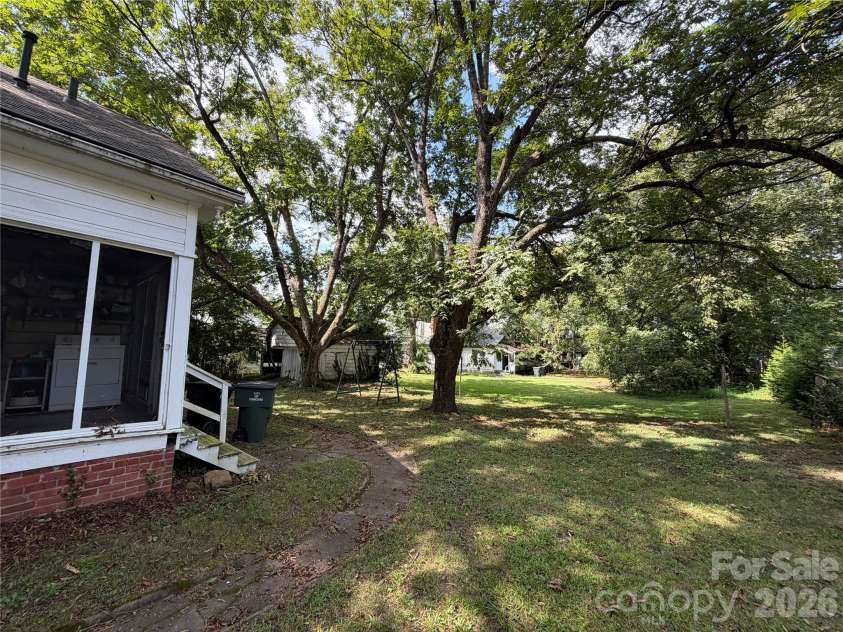 44 Academy Avenue, Concord, NC 28025.  MLS# CAR4432775, YatesRealty ID 55503. Back yard view from left side of house.