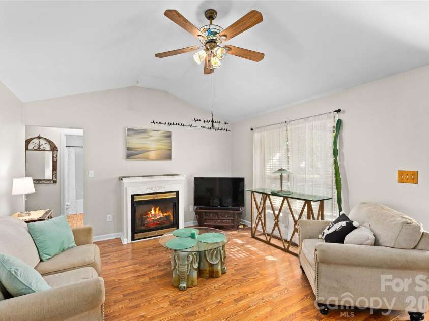4618 Hendrix Court, Concord, NC 28025.  MLS# CAR4431884, YatesRealty ID 55512. Den - Digitally enhanced, fire added to fireplace.