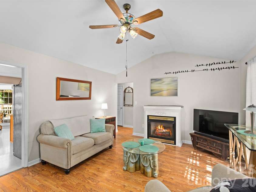 4618 Hendrix Court, Concord, NC 28025.  MLS# CAR4431884, YatesRealty ID 55512. Den - Digitally enhanced, fire added to fireplace.