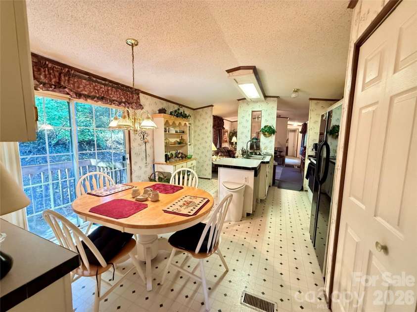 880 G W Whitmire Road, Rosman, NC 28772.  MLS# CAR4427376, YatesRealty ID 55565. Dining Area Open to Kitchen