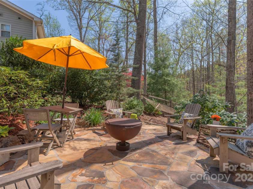 28 Sparkle Dun Drive, Biltmore Lake, NC 28715.  MLS# CAR4286512, YatesRealty ID 5557. Stone patio overlooking private, fenced yard