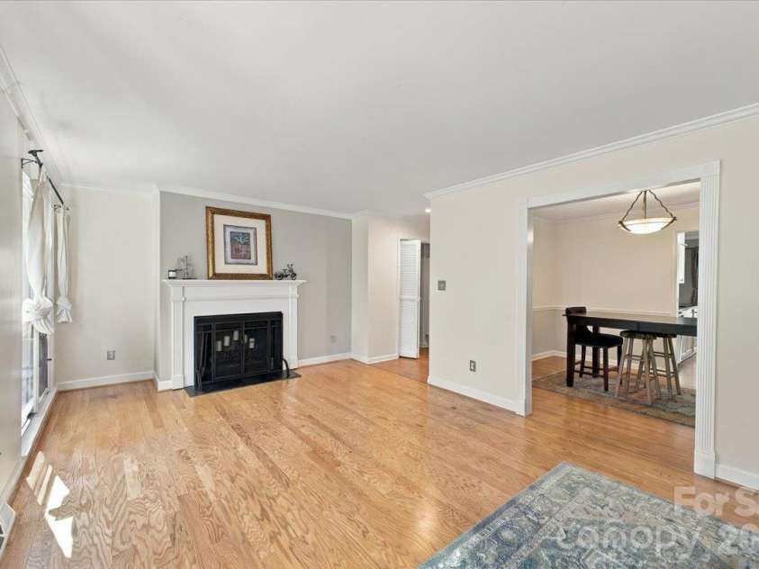 5805 Sharon Road, Charlotte, NC 28210.  MLS# CAR4432363, YatesRealty ID 55662. Living room with fireplace on main level