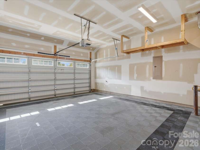 337 Belton Street, Charlotte, NC 28209.  MLS# CAR4431840, YatesRealty ID 55676. Attached two-car garage with interlocking tile flooring, overhead storage racks, LED lighting, and automatic garage door opener.