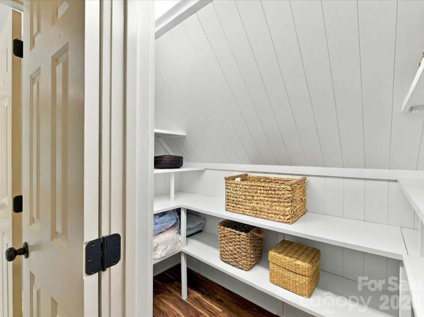 10709 Danesway Lane, Cornelius, NC 28031.  MLS# CAR4431451, YatesRealty ID 55685. These versatile storage spaces feature custom built-in shelving, charming paneled walls, and ample room for organizing seasonal items, household essentials, and additional belongings.