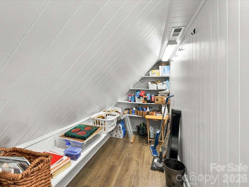 10709 Danesway Lane, Cornelius, NC 28031.  MLS# CAR4431451, YatesRealty ID 55685. These versatile storage spaces feature custom built-in shelving, charming paneled walls, and ample room for organizing seasonal items, household essentials, and additional belongings.