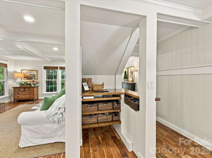 10709 Danesway Lane, Cornelius, NC 28031.  MLS# CAR4431451, YatesRealty ID 55685. This versatile flex space features a built-in workstation with wood countertops, convenient shelving and storage, rich hardwood floors, and charming architectural details, ideal for a home office or study nook.