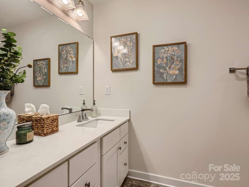 125 Lanyard Drive, Mooresville, NC 28117.  MLS# CAR4234396, YatesRealty ID 5571. Full bathroom upstairs with tile floor and large quartz counter and undermount sink.