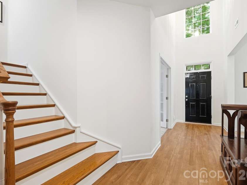 2100 Pineapple Court, Matthews, NC 28105.  MLS# CAR4431286, YatesRealty ID 55807. Hardwoods leading upstairs