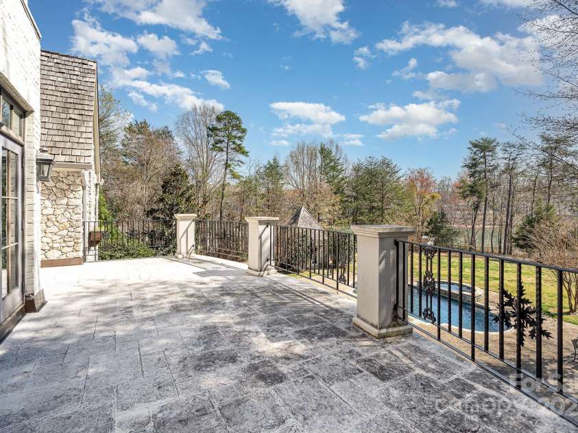 20711 Bethel Church Road, Cornelius, NC 28031.  MLS# CAR4225782, YatesRealty ID 5586. Primary bedroom balcony overlooking pool and lake