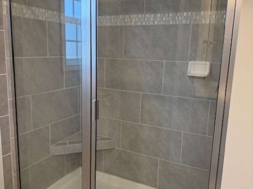 1030 Gardenia Drive, Mt Ulla, NC 28125.  MLS# CAR4322346, YatesRealty ID 5597. 5 ft tiled shower with bench