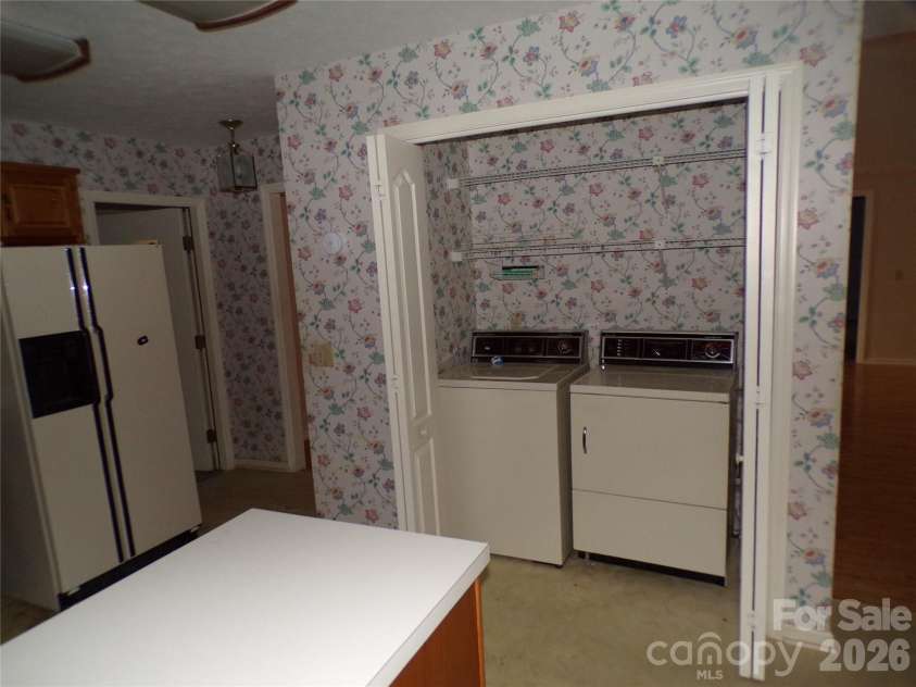 10 Governors Drive, Hendersonville, NC 28791.  MLS# CAR4433249, YatesRealty ID 55977. Kitchen laundry closet.