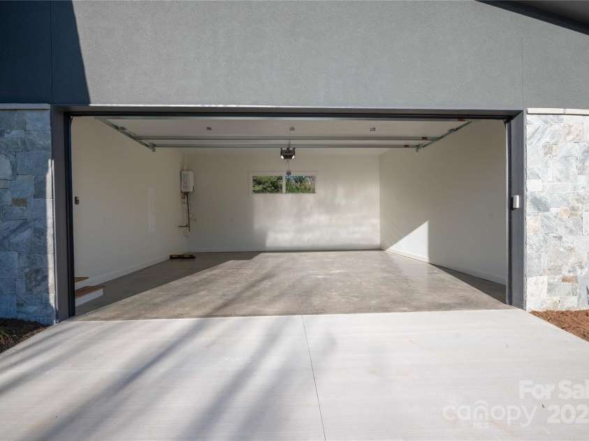 11 Kiftsgate Court, Asheville, NC 28804.  MLS# CAR4329278, YatesRealty ID 560. Garage generously sized with 18' garage door.