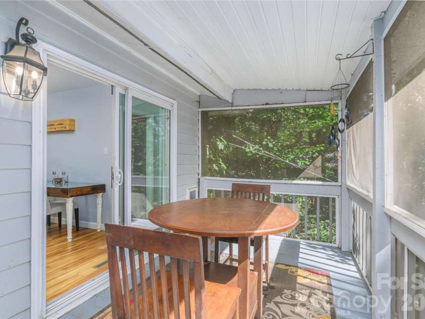 19 Springwood Drive, Asheville, NC 28805.  MLS# CAR4430580, YatesRealty ID 56029. Step out from the kitchen to an expansive screened back deck