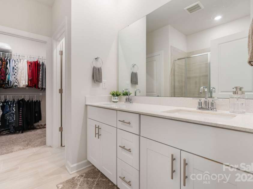 12425 Larue Lane, Huntersville, NC 28078.  MLS# CAR4231476, YatesRealty ID 5604. Beautiful primary bathroom includes huge walk-in closet, double vanity, and walk-in shower