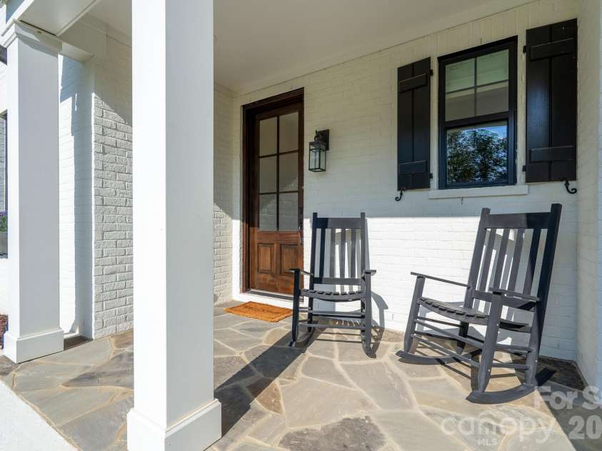 9588 Pacing Lane, Concord, NC 28027.  MLS# CAR4432011, YatesRealty ID 56073. Rocking Chair front Porch