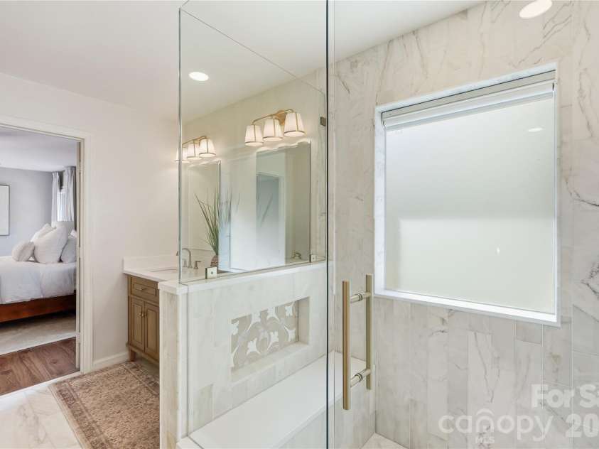 717 Fredricksburg Road, Matthews, NC 28105.  MLS# CAR4428487, YatesRealty ID 56079. Custom shower with hand sourced tile