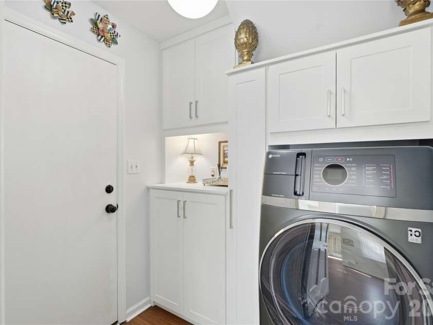 717 Fredricksburg Road, Matthews, NC 28105.  MLS# CAR4428487, YatesRealty ID 56079. Laundry room with california closet system to maximize storage organization