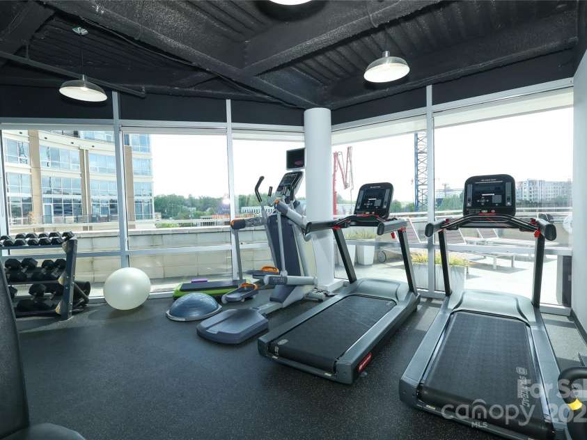 1100 Metropolitan Avenue, Charlotte, NC 28204.  MLS# CAR4241116, YatesRealty ID 5612. Workout facility overlooking the rooftop pool area.