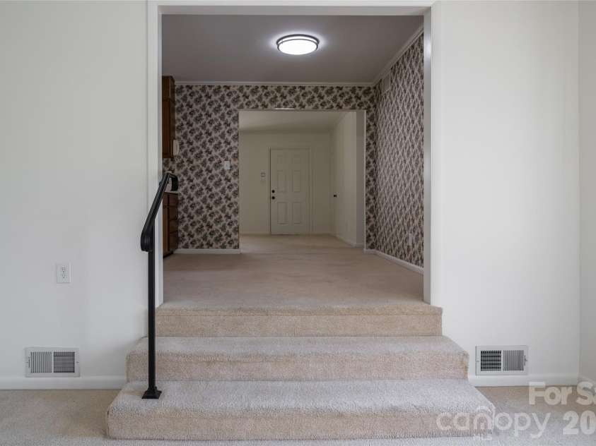 23 Wagon Road, Asheville, NC 28805.  MLS# CAR4433156, YatesRealty ID 56141. Den looking towards dining